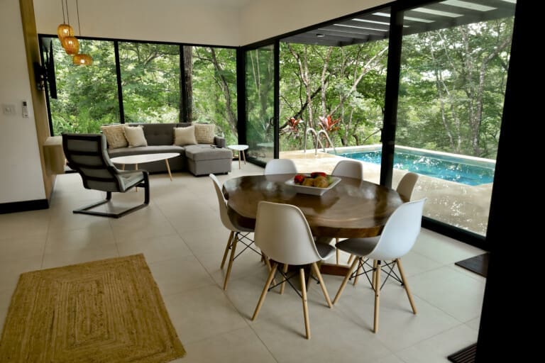 Dining area and living room with pool view at La Junglita, a private pool villa in Playa Junquillal, Costa Rica