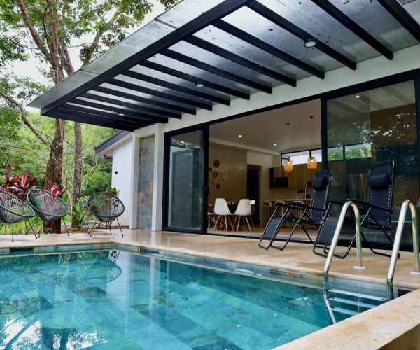 Private pool in front of the glass walled living area at La Junglita, a private pool villa in Playa Junquillal, Costa Rica